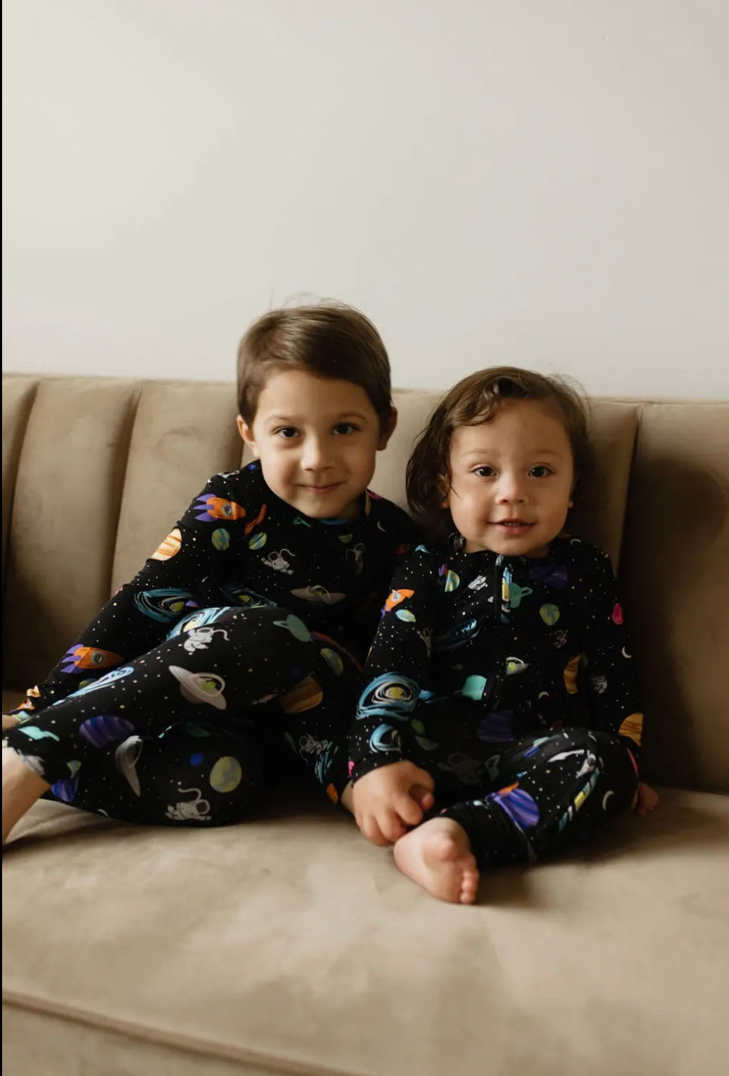 toddler boy and baby boy wearing matching bamboo baby and toddler pajamas with outer space print
