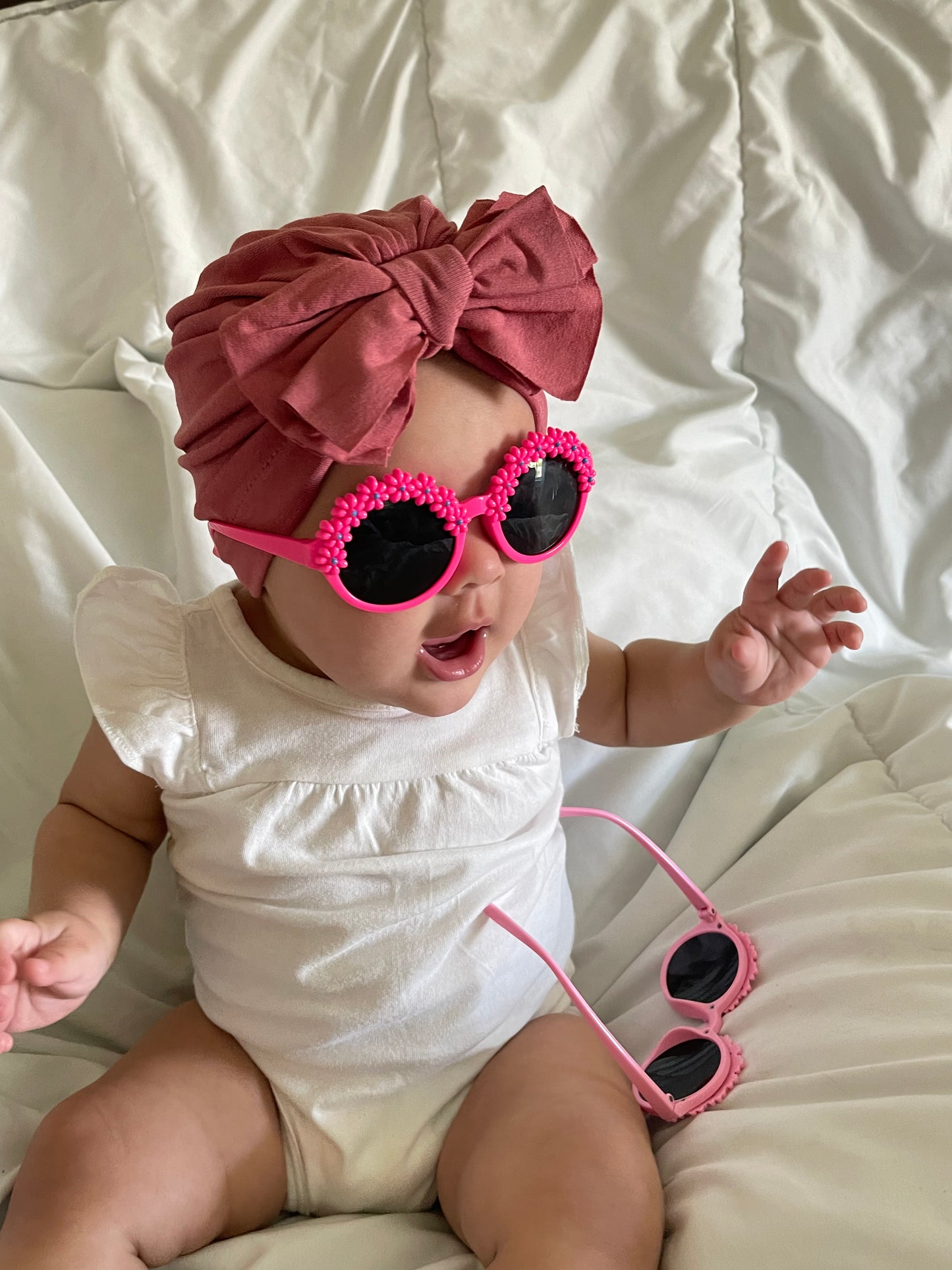 Baby girl wearing pink flower baby sunglasses